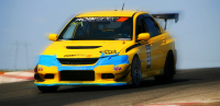 Yellow sports car with blue highlights and spoiler speeding on track. 